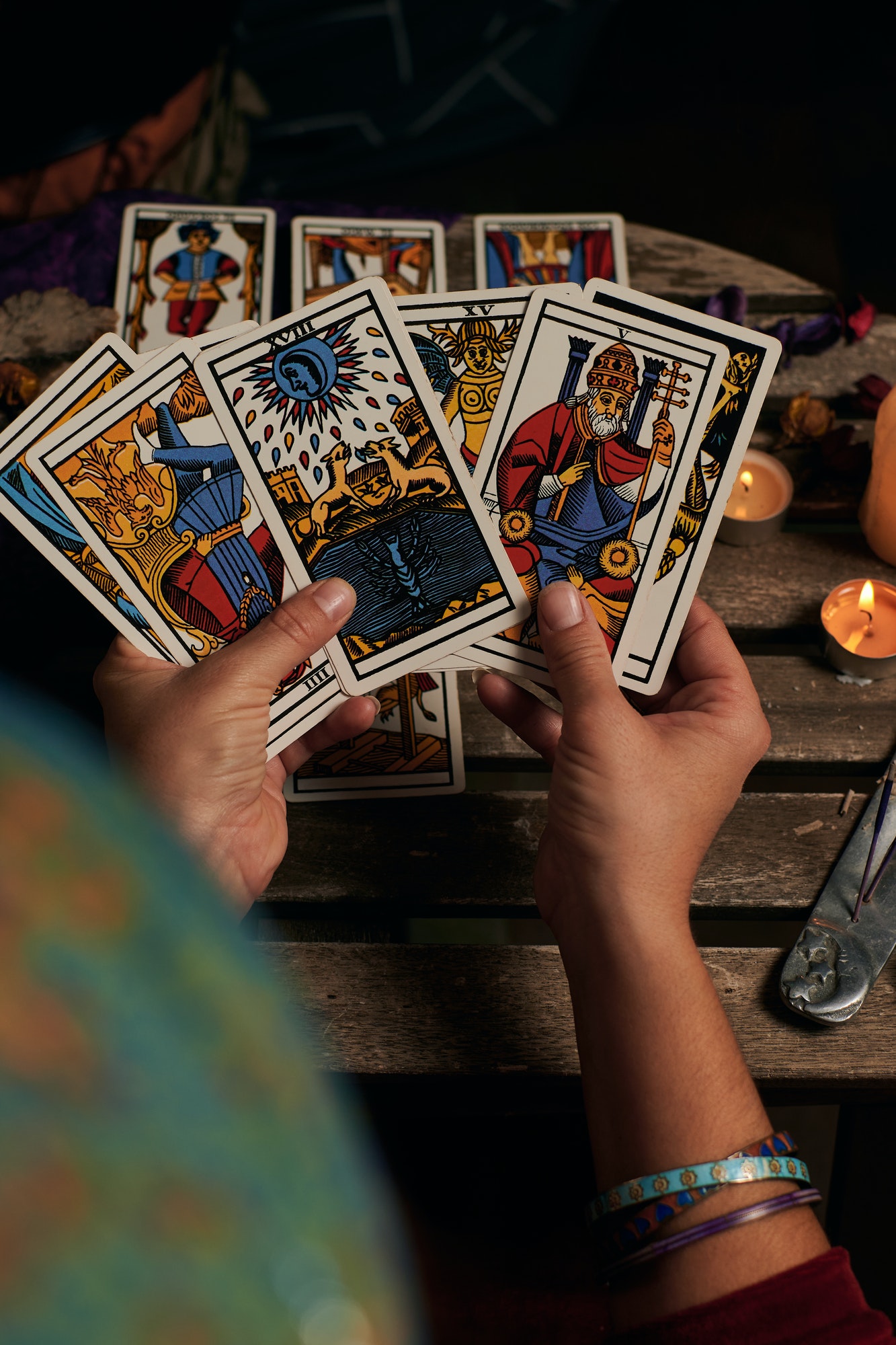 Close-up of a fortune teller reading tarot cards